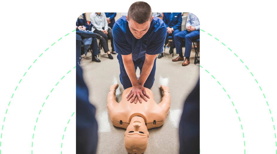 Instructor performing paediatric first aid training on a CPR mannequin with trainees watching