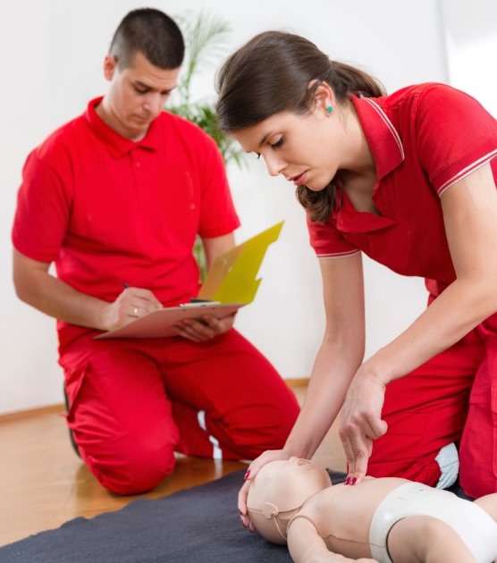 Trainers practising infant CPR during paediatric first aid training